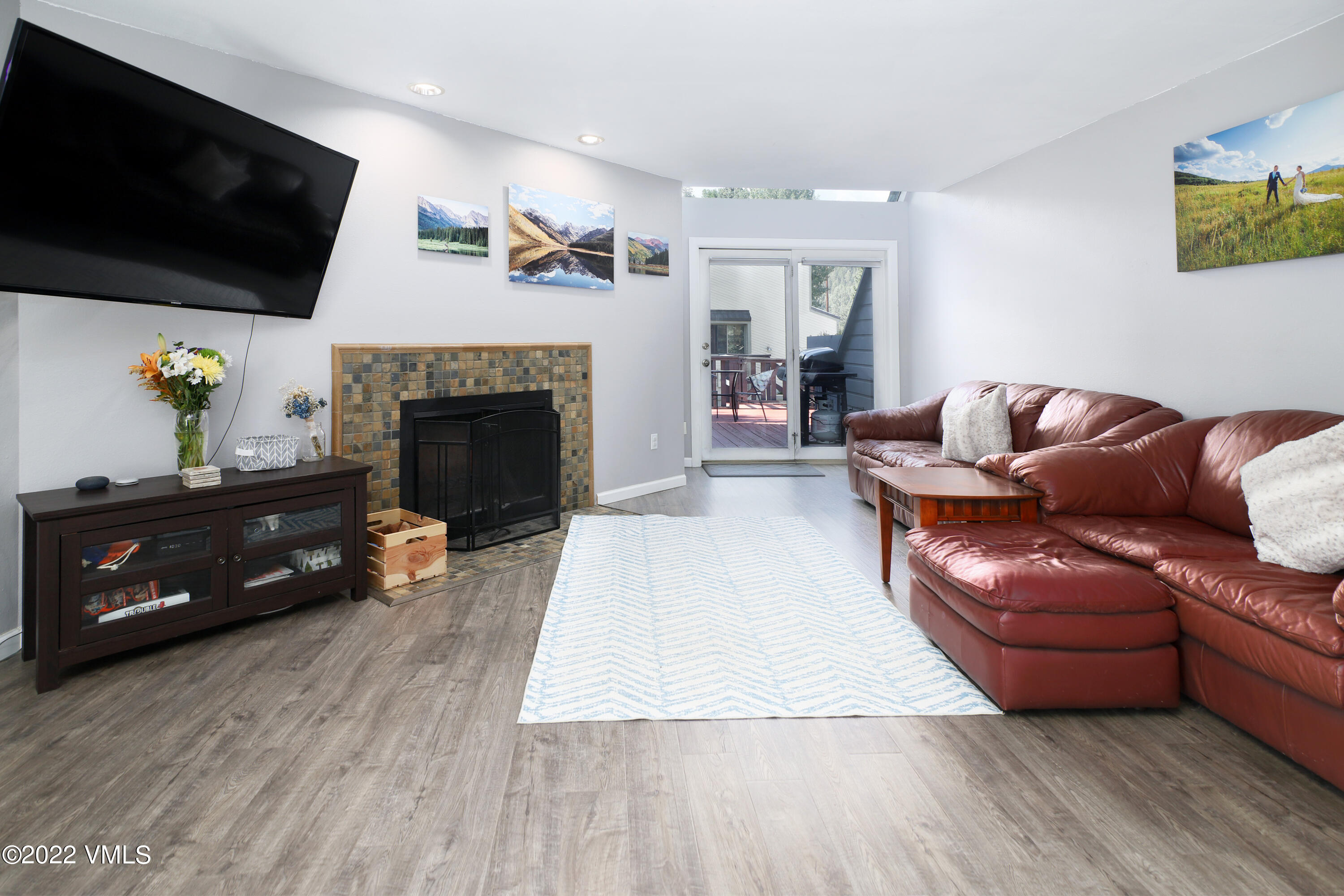 346 Eagle Road, Unit 2 Avon, CO 81620 - Photo 3 of 25 a living room with furniture a flat screen tv and a fireplace
