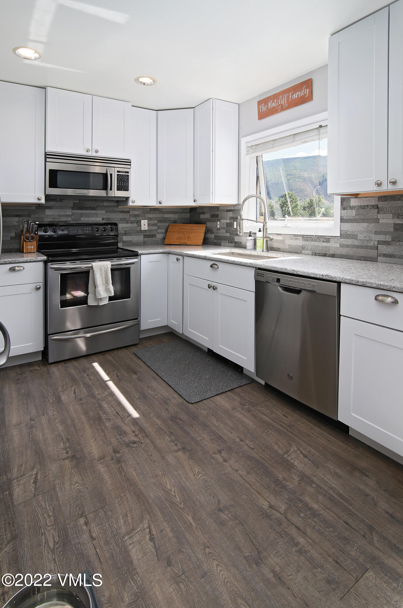 346 Eagle Road, Unit 2 Avon, CO 81620 - Photo 6 of 25 a kitchen with stainless steel appliances granite countertop a stove a sink and a microwave