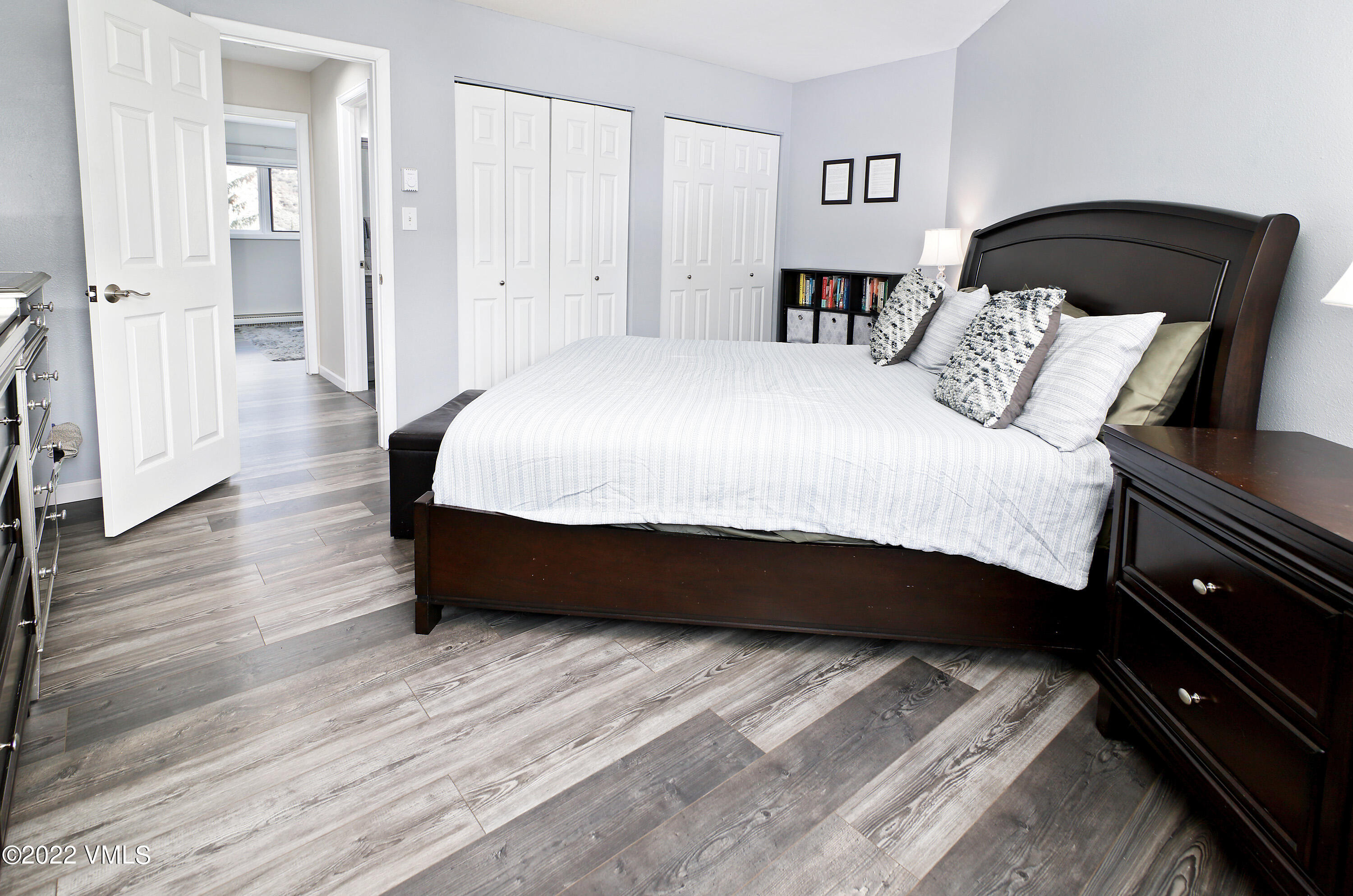 346 Eagle Road, Unit 2 Avon, CO 81620 - Photo 9 of 25 a spacious bedroom with a bed and wooden floor