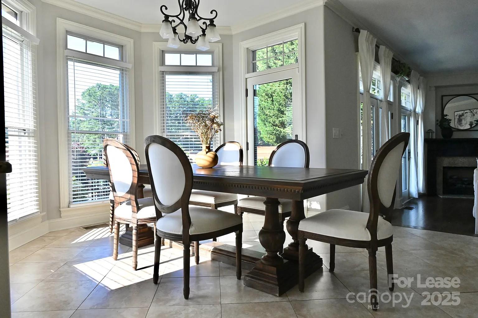 17234 Jetton Road Cornelius, NC 28031 - Photo 14 of 32 a view of a dining room with furniture window and wooden floor