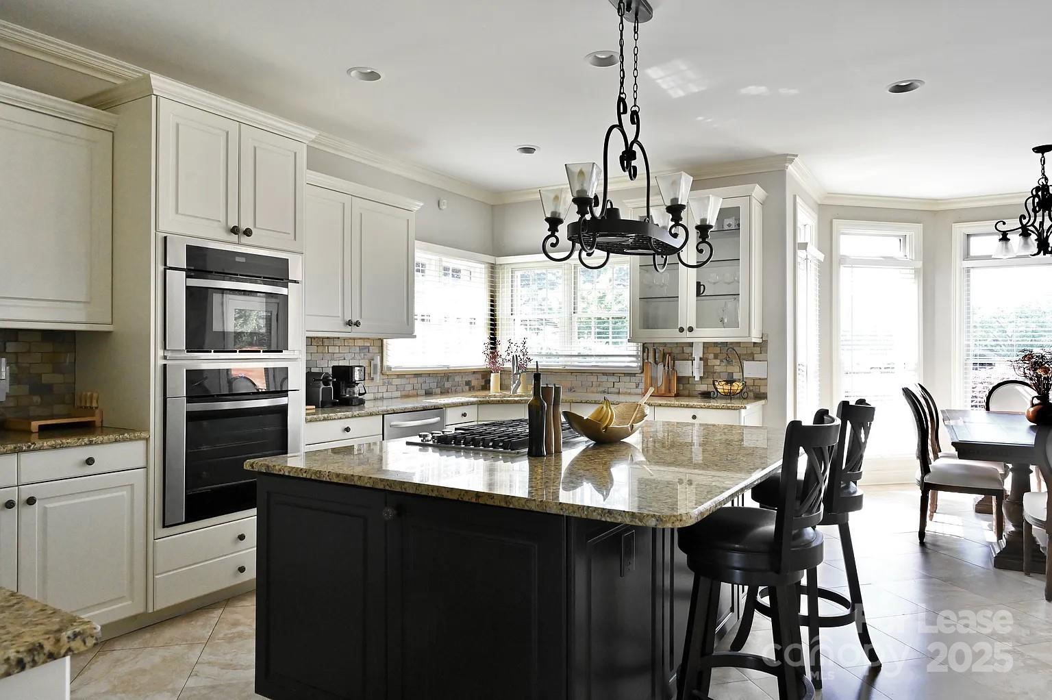 17234 Jetton Road Cornelius, NC 28031 - Photo 15 of 32 a kitchen with refrigerator cabinets dining table and chairs