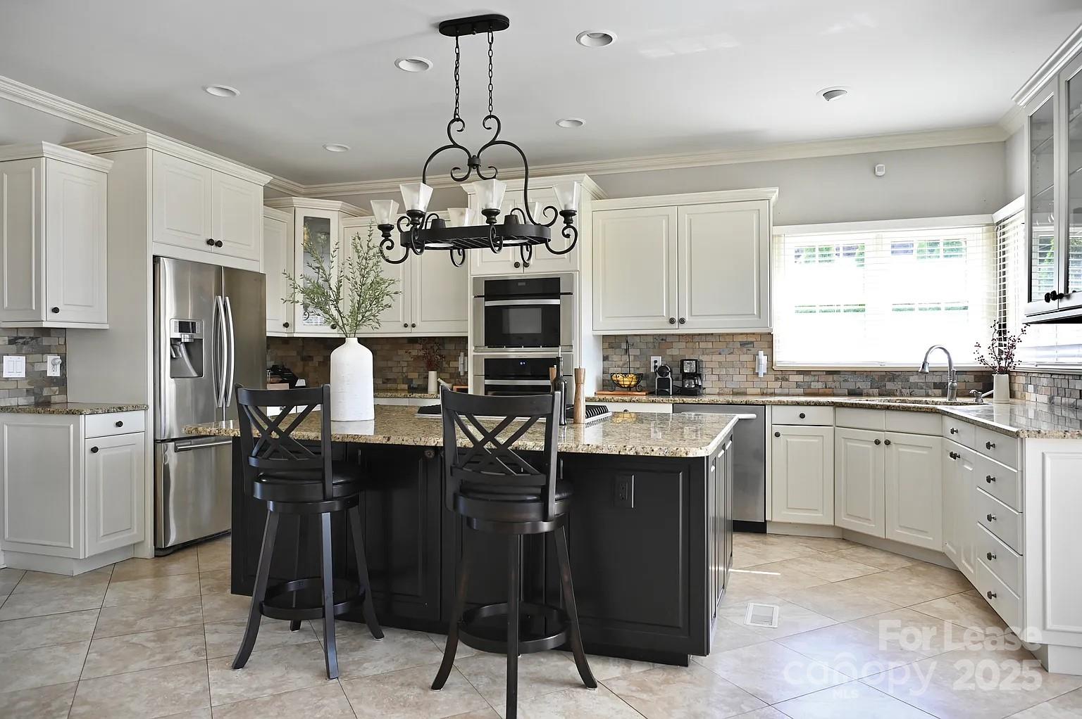 17234 Jetton Road Cornelius, NC 28031 - Photo 16 of 32 a kitchen with stainless steel appliances granite countertop a sink a stove a refrigerator and cabinets