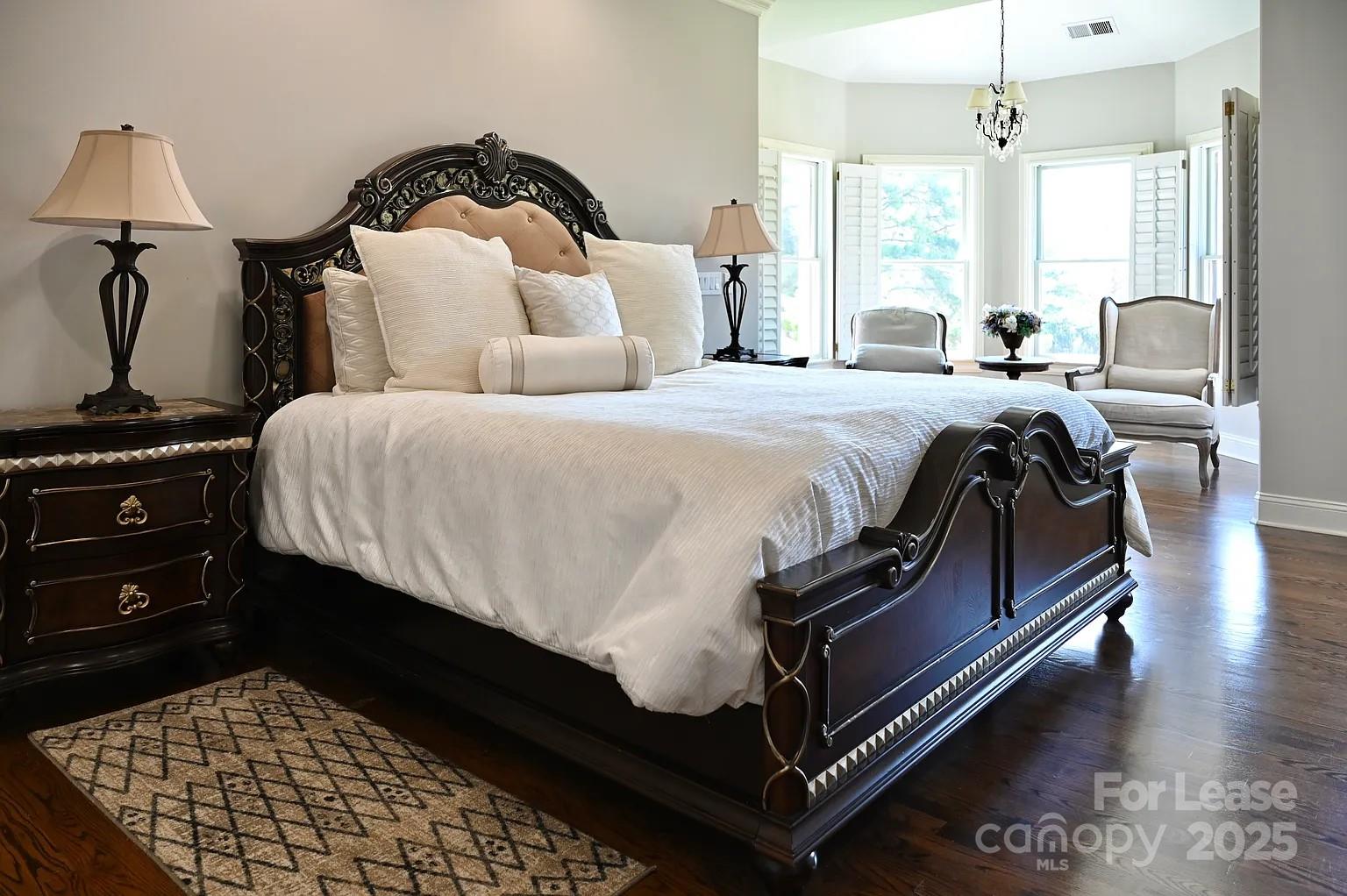 17234 Jetton Road Cornelius, NC 28031 - Photo 19 of 32 a bedroom with a bed and wooden floor