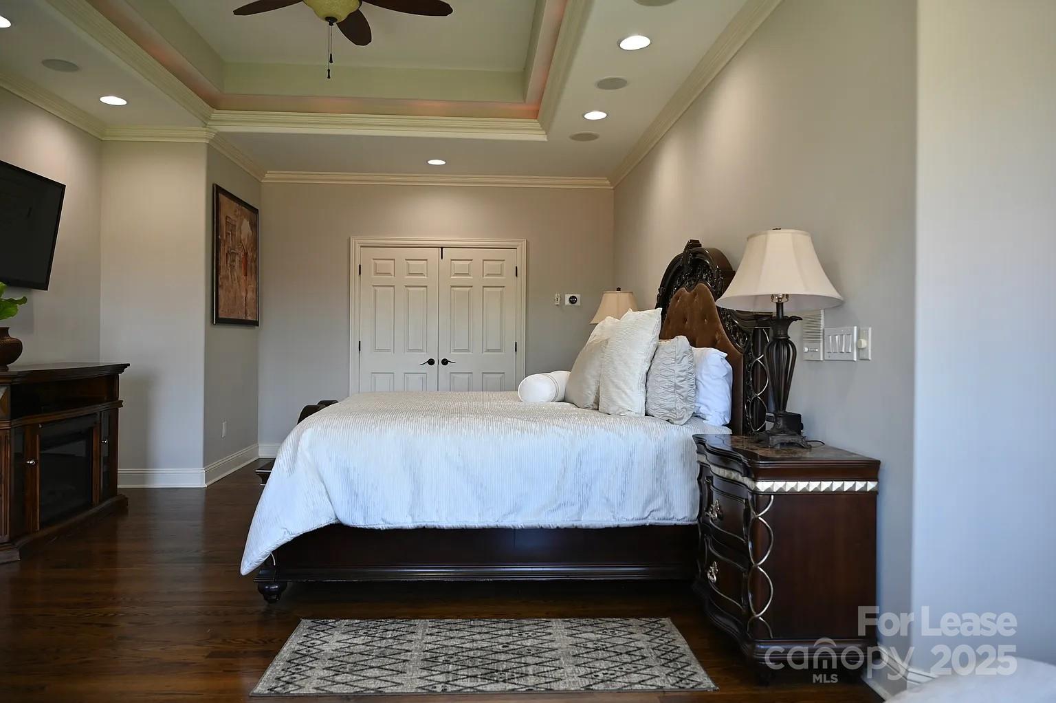 17234 Jetton Road Cornelius, NC 28031 - Photo 20 of 32 a bed room with a bed and a television