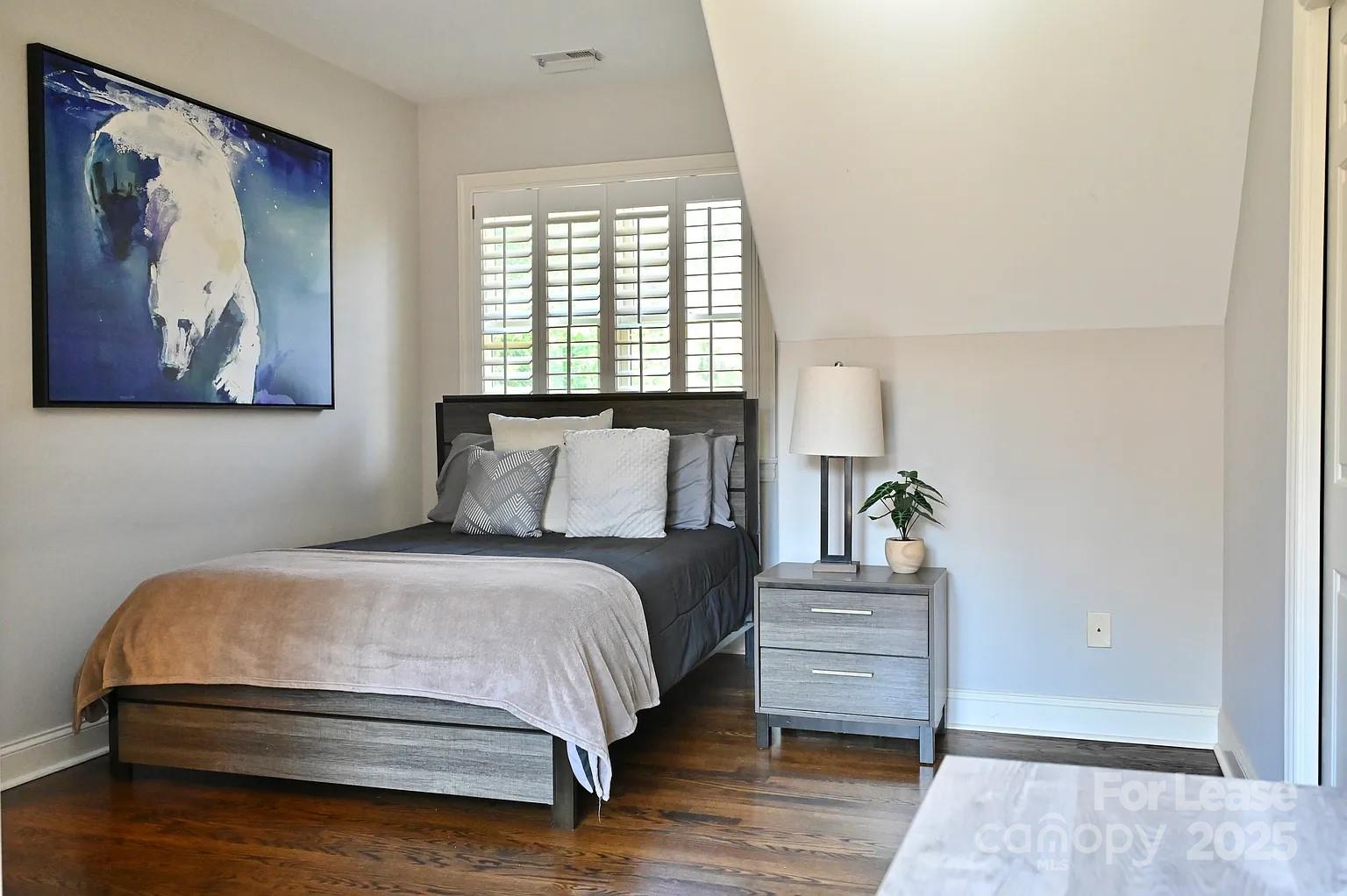 17234 Jetton Road Cornelius, NC 28031 - Photo 26 of 32 a bedroom with a bed and a painting on the wall