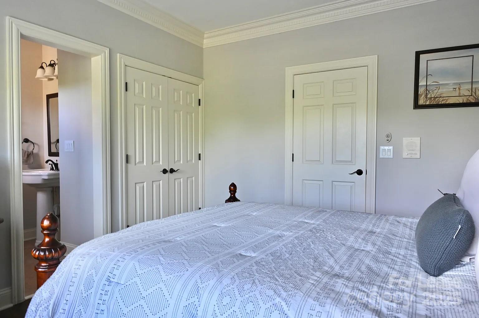 17234 Jetton Road Cornelius, NC 28031 - Photo 27 of 32 a bedroom with a bed and a wooden floor