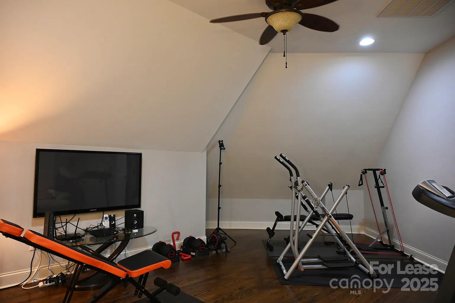 17234 Jetton Road Cornelius, NC 28031 - Photo 29 of 32 a room with gym equipment and windows