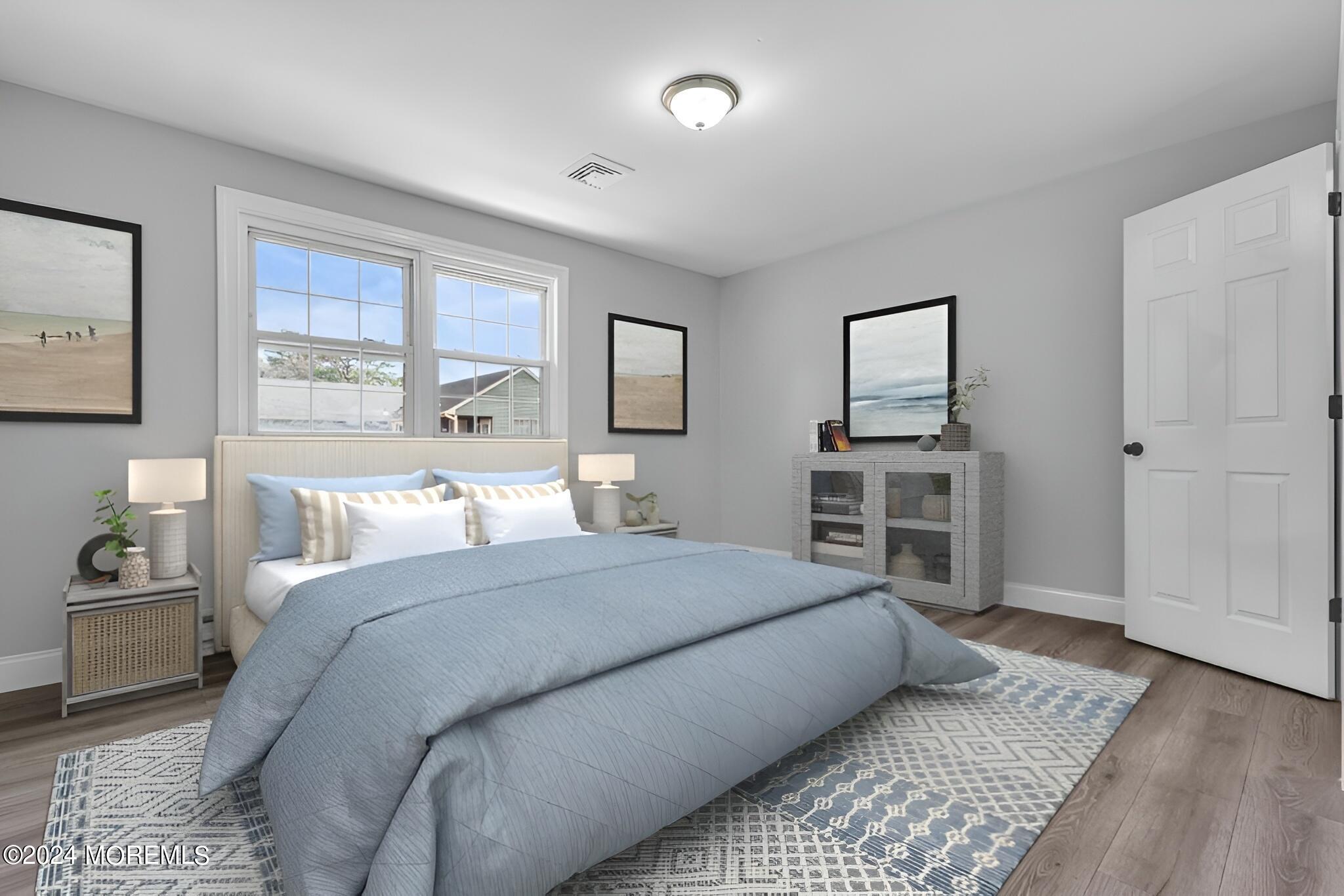 7 A Spring Street, Unit 50 Whiting, NJ 08759 - Photo 15 of 16 a bedroom with a bed and a large window