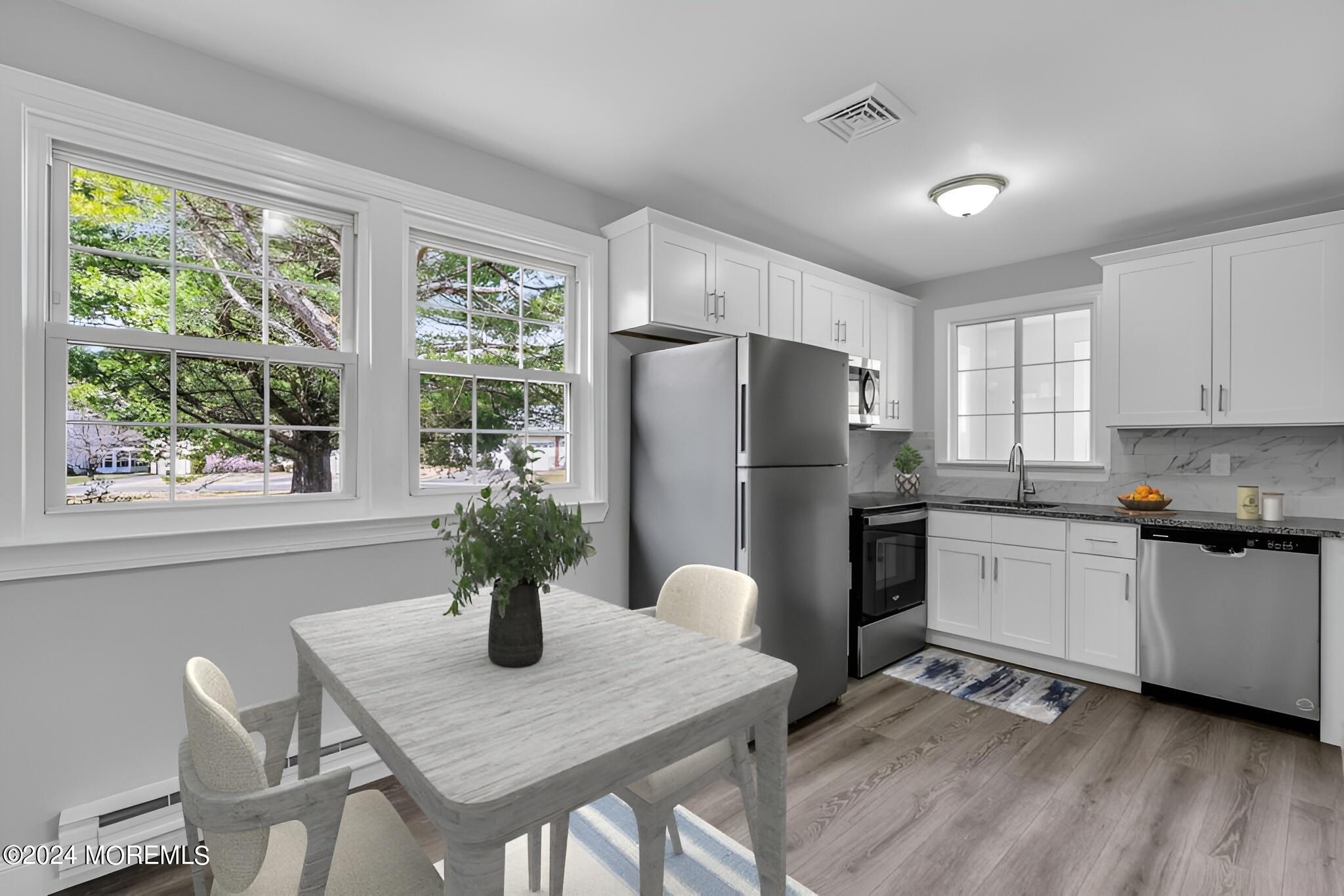 7 A Spring Street, Unit 50 Whiting, NJ 08759 - Photo 8 of 16 a kitchen with refrigerator and wooden cabinets