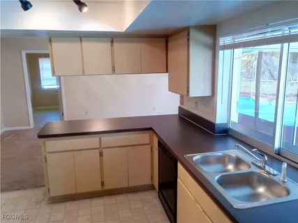 a kitchen with a refrigerator and a stove