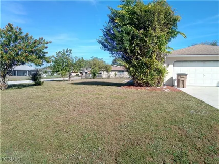 a view of a house with a yard and garage