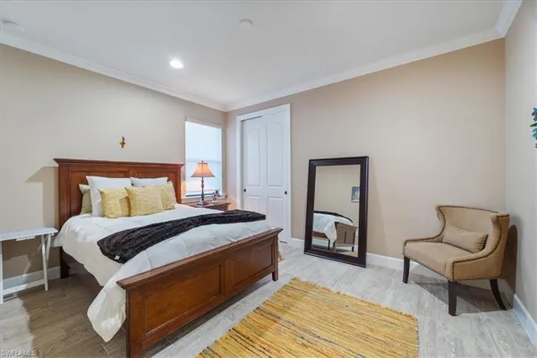 a bedroom with a bed and chair