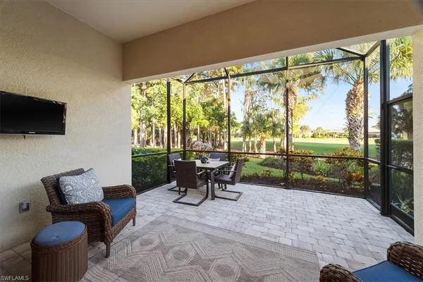a view of a patio with a table chairs and a flat screen tv