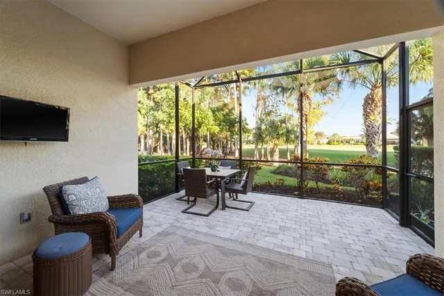 a view of a patio with a table chairs and a flat screen tv