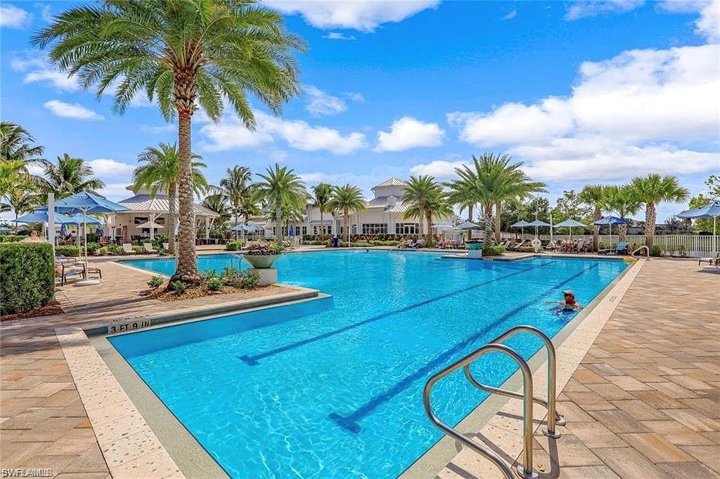 9418 Greyhawk Trail Naples, FL 34120 - Photo 27 of 34 a view of a swimming pool with lounge chair