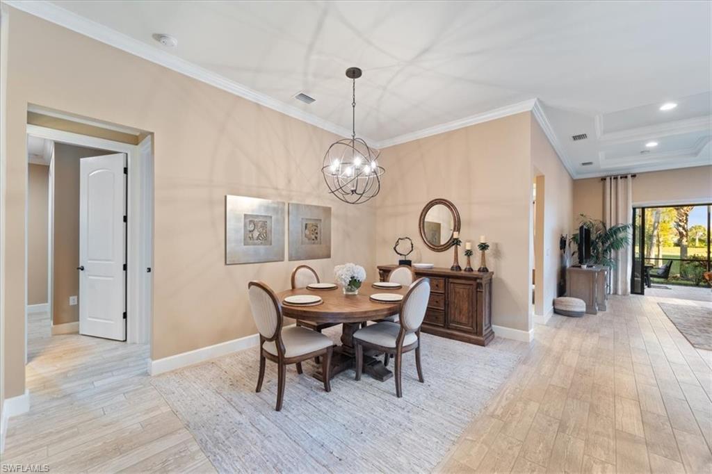 9418 Greyhawk Trail Naples, FL 34120 - Photo 4 of 34 a view of a dining room with furniture window and wooden floor