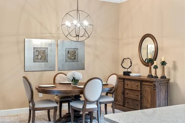 a view of a dining room with furniture and chandelier