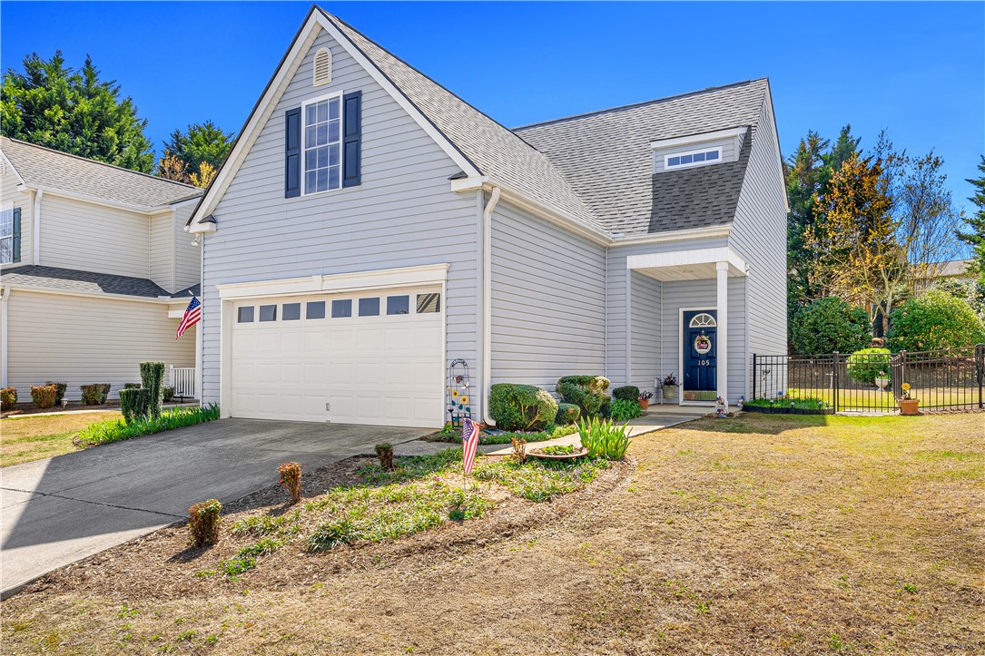 This charming home presents a classic facade with thoughtful landscaping.