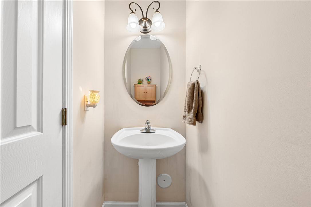 105 Ledgewood Way Easley, SC 29642 - Photo 14 of 33 This clean and functional bathroom features a classic pedestal sink and elegant oval mirror.