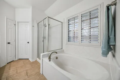 a bathroom with a bathtub and a shower
