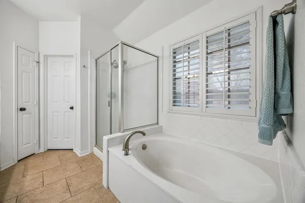 a bathroom with a bathtub and a shower