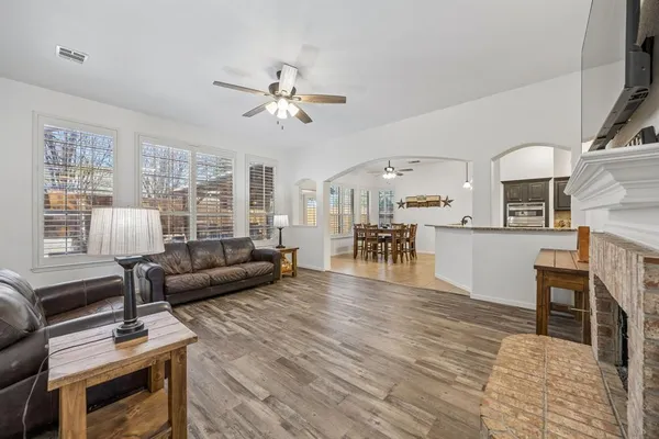a living room with furniture and a wooden floor