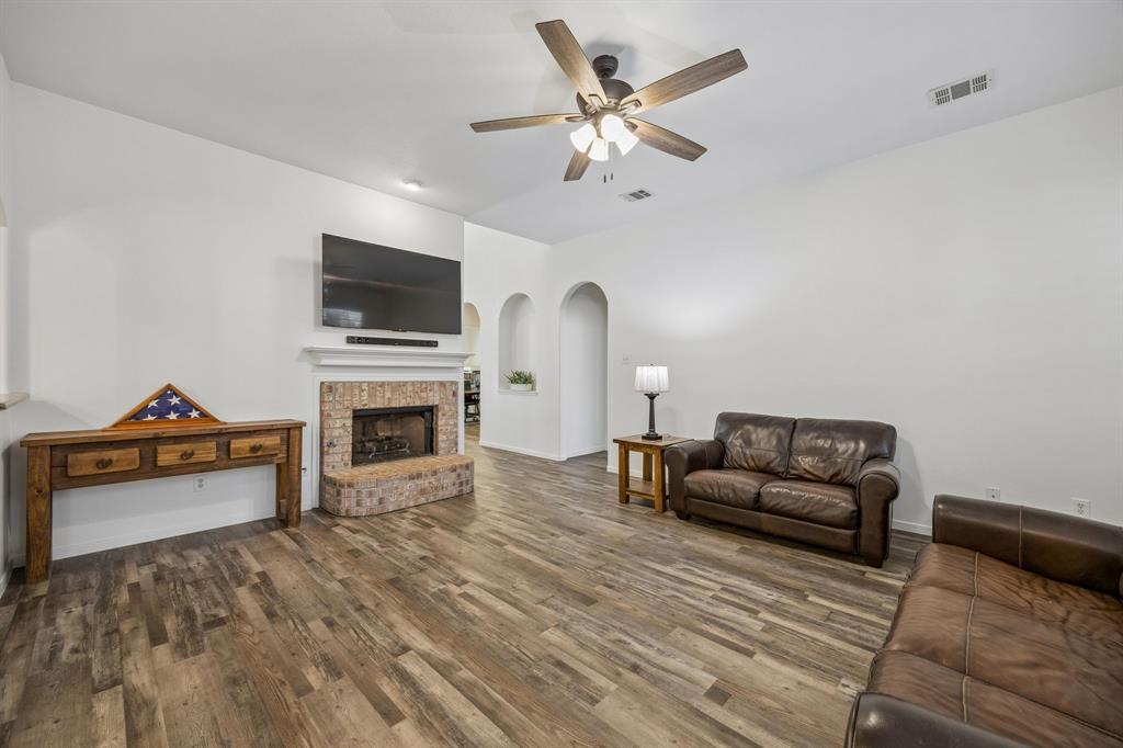 5 Cimarron Court Trophy Club, TX 76262 - Photo 16 of 30 a living room with furniture flat screen tv and a fireplace