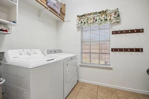 a utility room with a sink dryer and washer