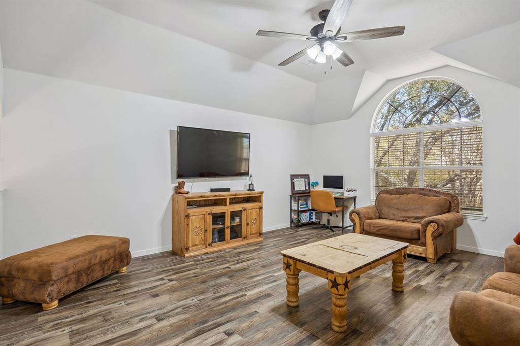 5 Cimarron Court Trophy Club, TX 76262 - Photo 24 of 30 a living room with furniture a chandelier and a flat screen tv