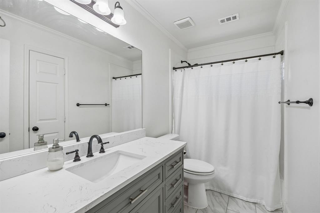 5 Cimarron Court Trophy Club, TX 76262 - Photo 26 of 30 a bathroom with a sink toilet and shower