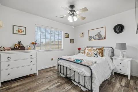 a bedroom with a large bed and a window