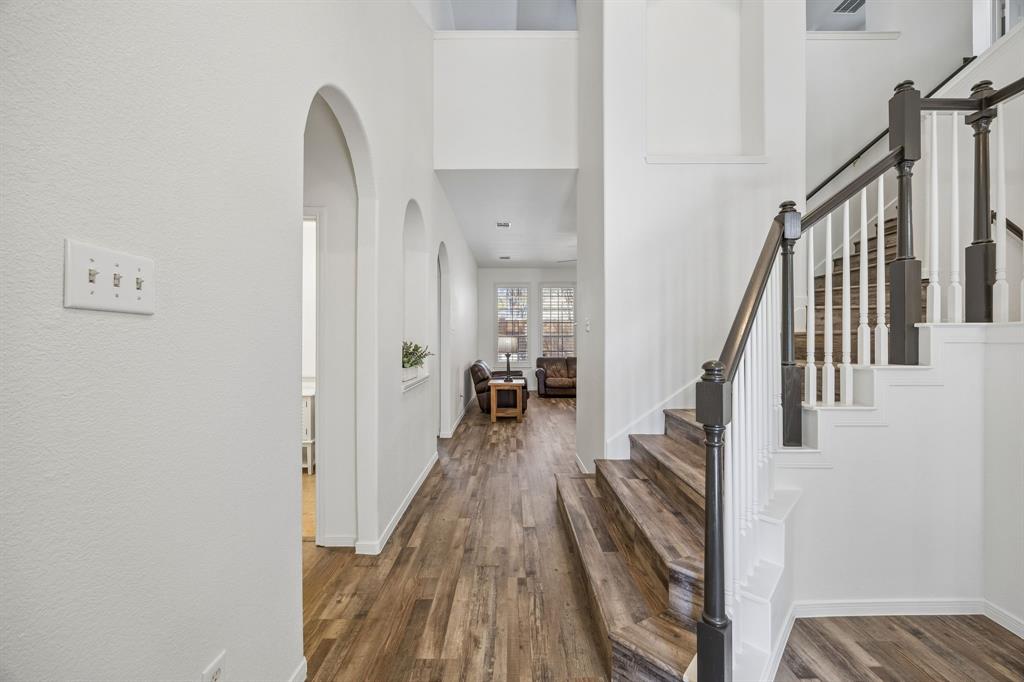 5 Cimarron Court Trophy Club, TX 76262 - Photo 6 of 30 a view of a hallway with wooden floor and staircase