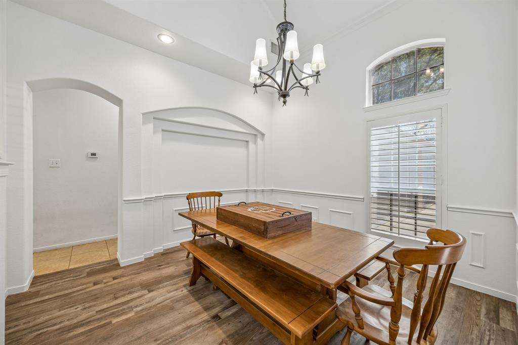 5 Cimarron Court Trophy Club, TX 76262 - Photo 7 of 30 a room with chandelier table and windows
