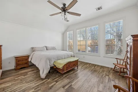 a spacious bedroom with a bed and a table