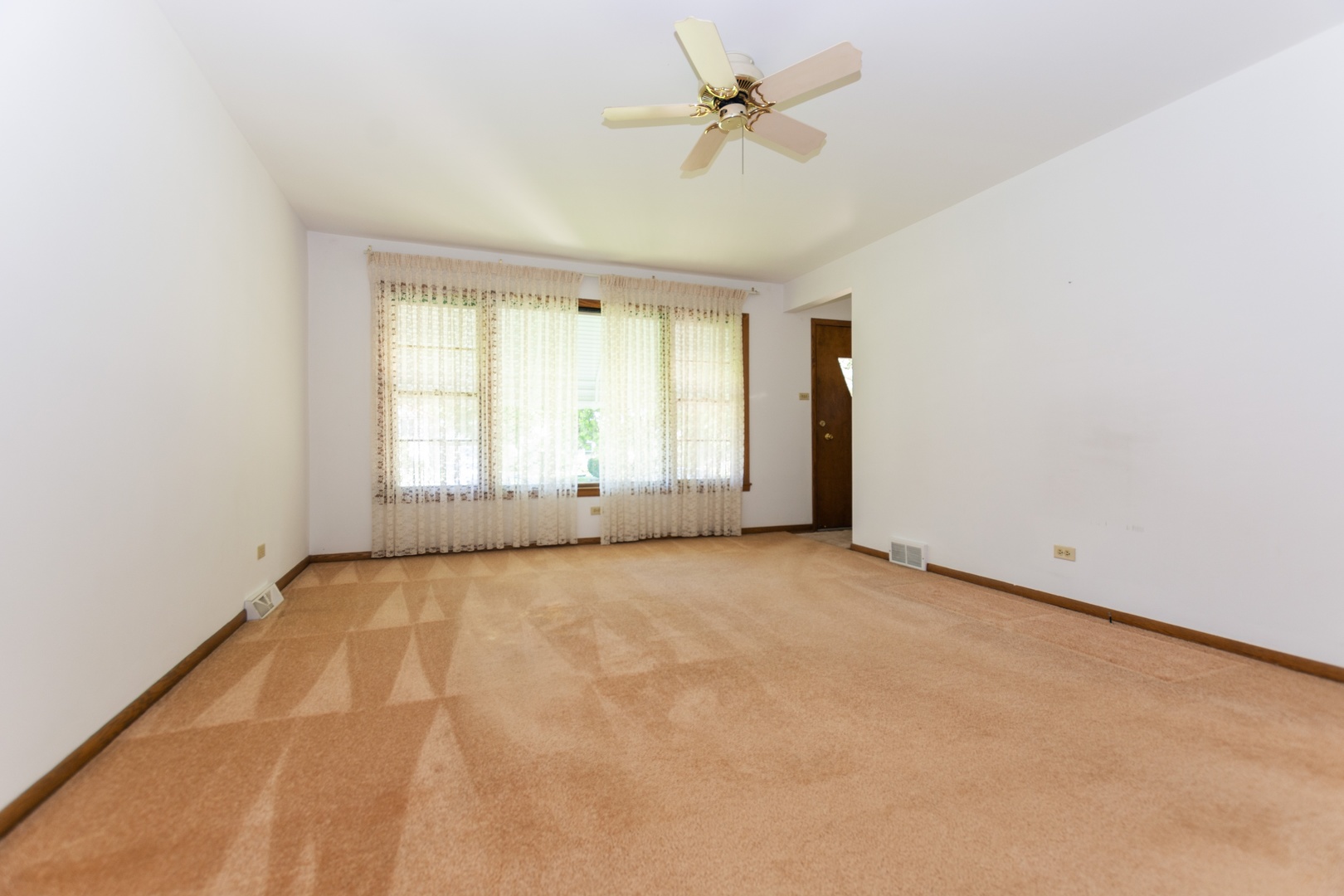 10621 Princess Avenue Chicago Ridge, IL 60415 - Photo 2 of 13 an empty room with windows and ceiling fan view