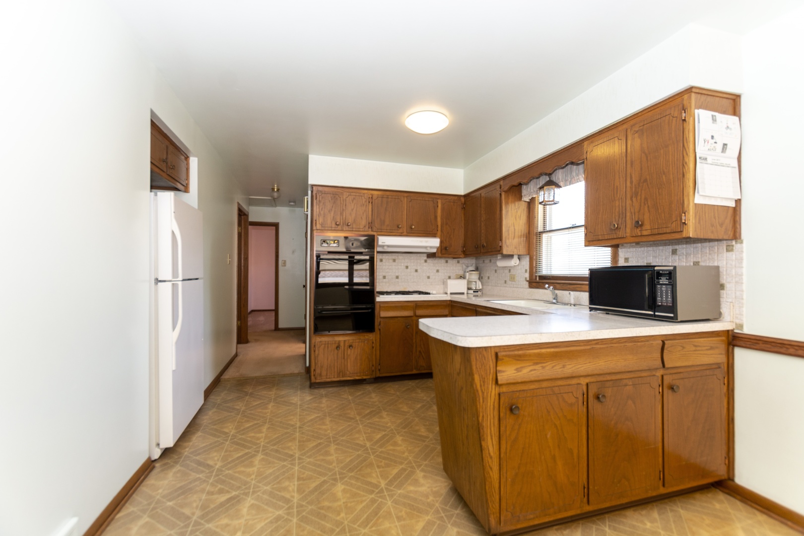 10621 Princess Avenue Chicago Ridge, IL 60415 - Photo 3 of 13 a kitchen with cabinets and a refrigerator