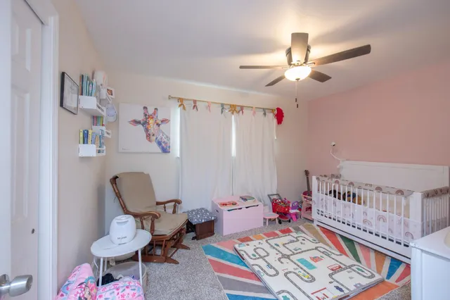a bedroom with furniture and a rug