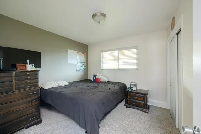 a bedroom with a bed and a closet