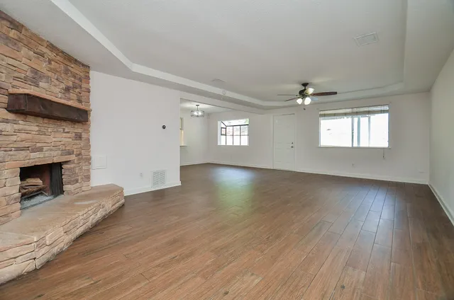 a view of a livingroom with wooden floor and fireplace