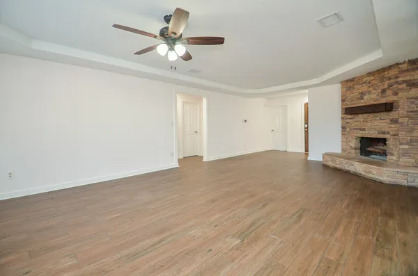wooden floor in an empty room with a fireplace