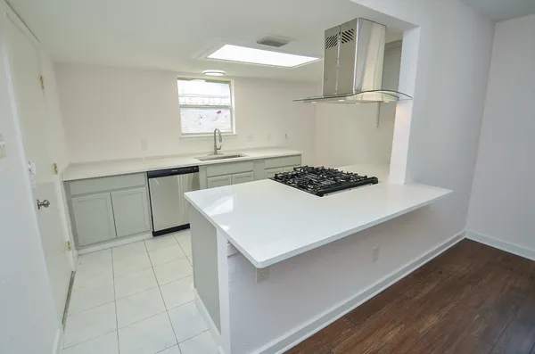 a kitchen with a sink cabinets and window