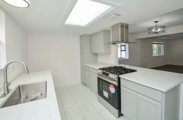 a kitchen with a stove and a sink
