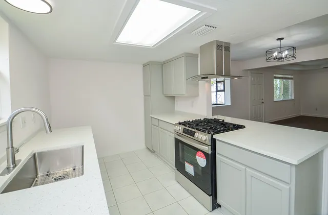 a kitchen with a stove and a sink