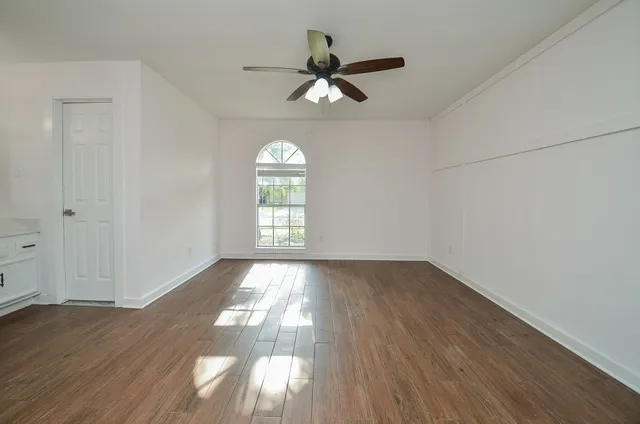wooden floor in an empty room with a window