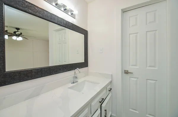 a bathroom with a sink and a mirror
