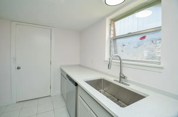 a kitchen with a sink cabinets and window