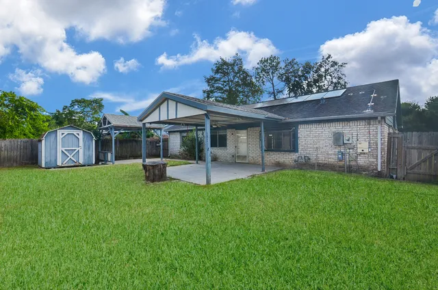 a front view of a house with a garden and yard