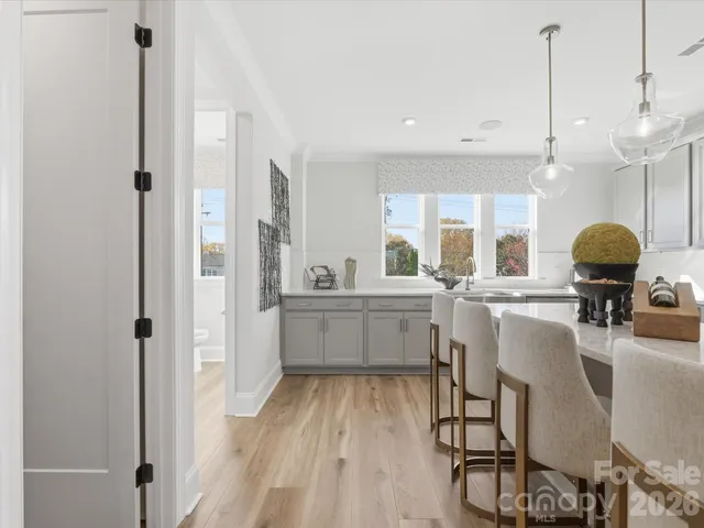 a kitchen with stainless steel appliances granite countertop a stove and cabinets with wooden floor