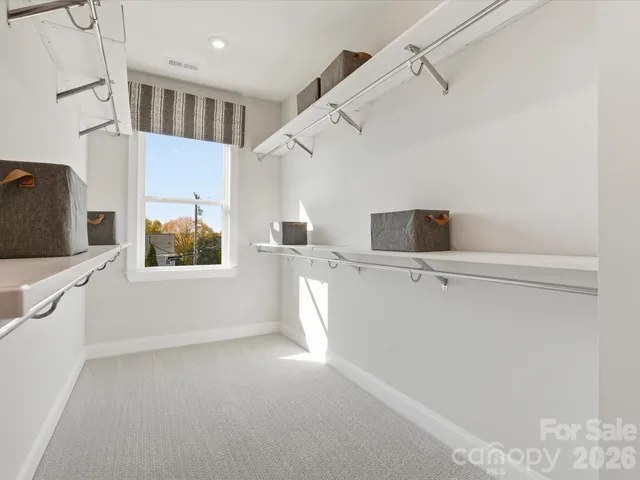 a living room with furniture a fireplace and a floor to ceiling window