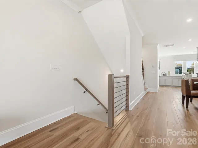 a living room with furniture a flat screen tv and a floor to ceiling window